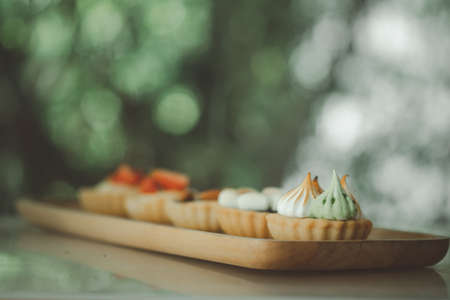 Homemade mini tart on wood tray at homeの写真素材