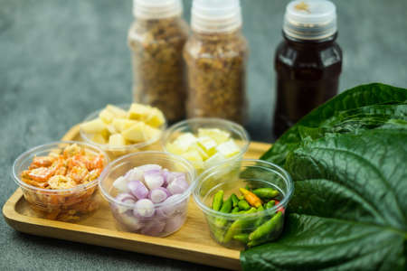Thai appetizer Miang Kum leaf-wrapped bite-size for eat is a traditional Southeast Asian snack from Thailandの写真素材