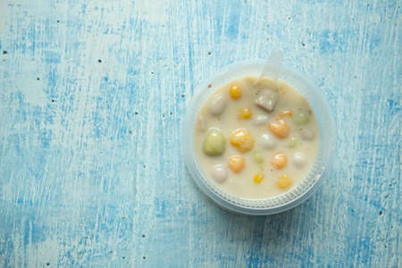 Thai Dessert name Bualoy or ( Bua Loy ) Rice balls colourful in sweet creamy coconut milk syrup in bowl box. Bua loy is the best dessert menu recommended in Thailand.の写真素材