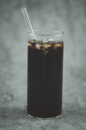 Thai style ice black coffee in a tall glass. Cold summer drink