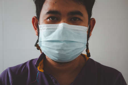 Close up of young asian man wearing a face maskの写真素材