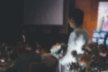 A blurred photograph of the wedding ceremony groom in a white dress with the bridal bouquet in handの写真素材