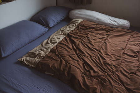 Classic family bedroom with comfortable bed headboard pillowsの写真素材