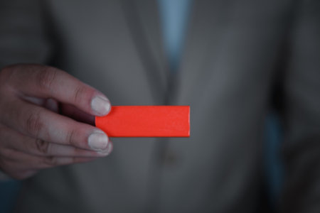 Businessman in brown suit show empty wooden red blockの写真素材