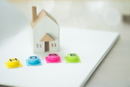 White home and colourful silicone tex home placed on white paper