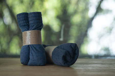 Rolled up boxer briefs in paper brown packaging on wood tableの写真素材