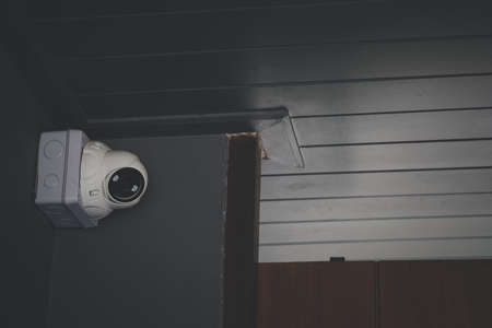Security CCTV camera or surveillance system on the exterior of a building.の写真素材