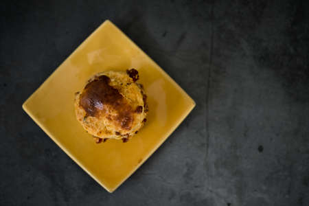 Freshly baked scones on a yellow saucer. Top viewの写真素材