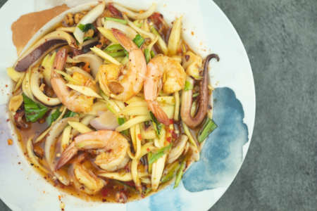 Mango spicy salad with seafood hot and spicy tasty appetizer. Thai appetizerの写真素材