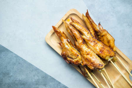 BBQ grilled chicken wings in bamboo stick. Thai style foodの写真素材