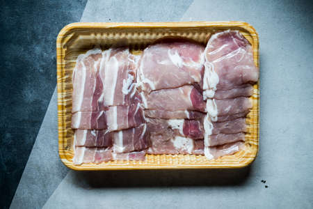 Thinly-sliced raw pork in packaging, top viewの写真素材