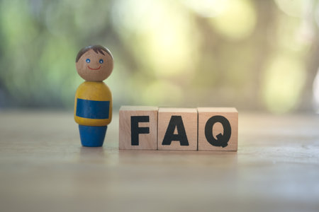 Wooden blocks with the word FAQ (frequently asked questions). Collection of frequently asked questions on any topic and answers to them. Instructions and rules on Internet sitesの写真素材