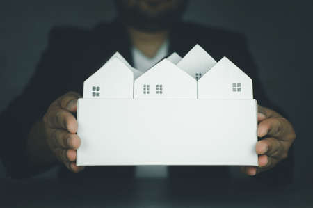 Real estate broker residential house rent offer of purchase house of real estate, giving, offering, demonstration, handing house new home.の写真素材