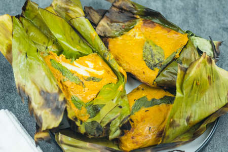Opened steamed seafood with curry paste in banana leafの写真素材