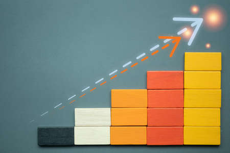 Wooden block business growth with arrow up. Business growth rates, creative ideas graph business development to grow profit and success for target concept.の写真素材