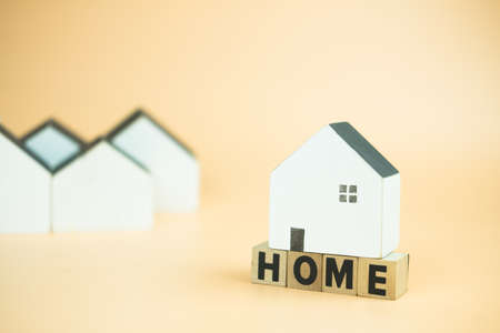 Mini wood house placed on word of HOME. The concept of demand for housing.の写真素材