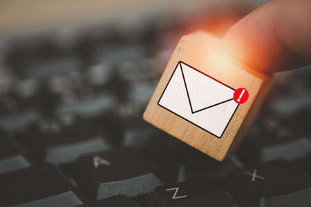 Man touching cube block with envelope and notifications symbol icon for the new E-Mail message inbox. The concept of computer browsing communicationの写真素材