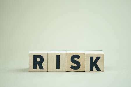 Wooden cubes with the word risk. Risk taking, risk management or assessment concept. Eliminate risk...
