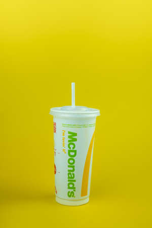 Samut Prakan, Thailand - October 24, 2021 : A drink cup of McDonald's with plastic straw with logo the world's largest fast food restaurantsのeditorial素材