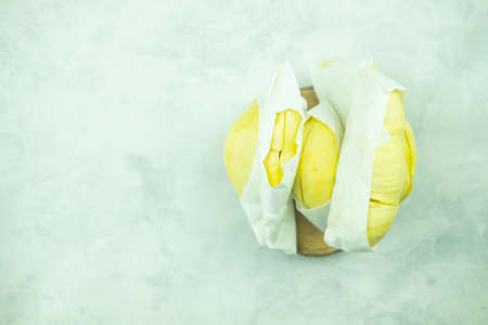 Fresh durian from Thailand wrapped with white paper. Top view