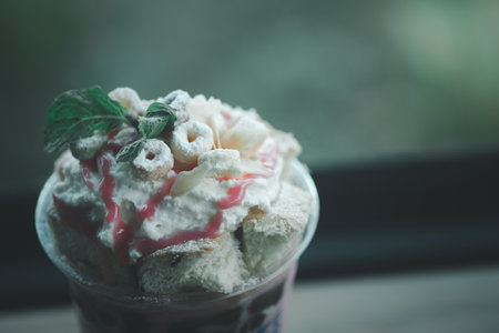 A glass of fresh milk ice with toast and strawberry sauce. Close upの写真素材