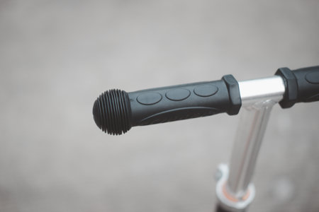 Close up of handlebar on a kid scooter. Selective focus.