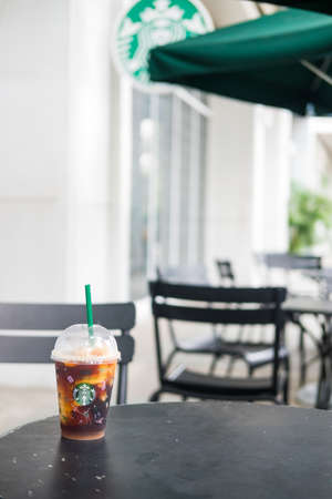 Bangkok, Thailand - October 29, 2021 : Yuzu Cold Brew in a reusable cup with a special 50th anniversary design at Starbucks cafe coffee shop, Starbucks is the world's largest coffee houseのeditorial素材