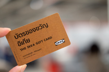 Samut Prakan, Thailand - October 31, 2021 : A hand holding IKEA gift card is the Thai language, IKEA gift card is one of good idea for wedding gift to friends and familyのeditorial素材