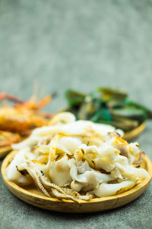 Slice of grilled squid on wood dish. Selective focusの写真素材