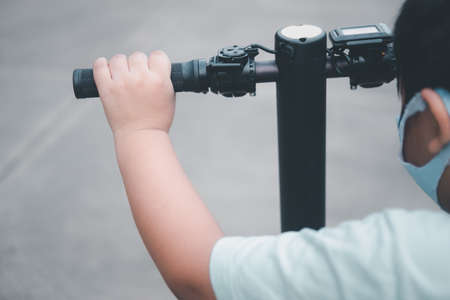Close up a baby boy playing scooterの写真素材