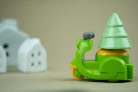 Toy motorbike carry with Christmas tree delivery to home at Christmas day. Theme Christmas day background.の写真素材