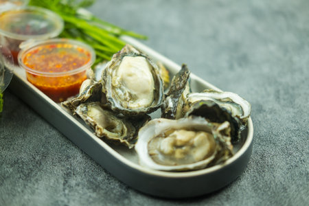Raw oyster shell with spicy sauce in Thai food styleの写真素材