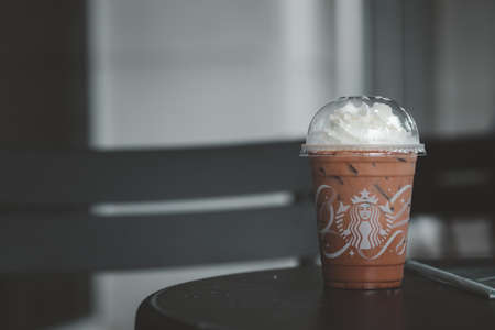 Samut Prakan, Thailand - November 21, 2021 : Glass of Starbuck coffee iced mocha on top with whipped...