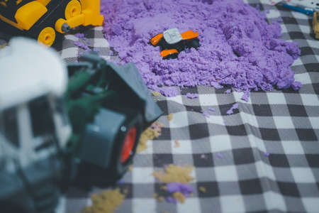 Selective focustoy car placed on violate kinetic sand, interesting kids gameの写真素材