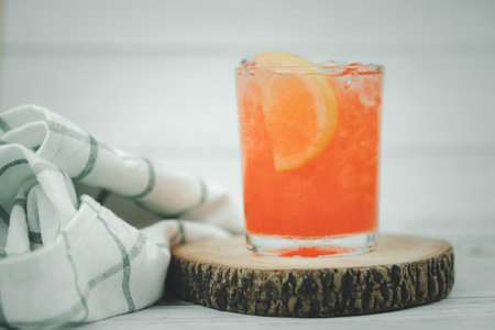 Cold and refreshing punch with an orange slice. Summer drink.