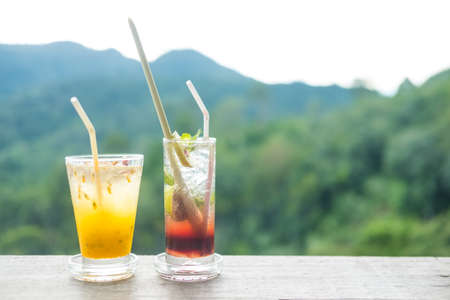 Summer drink on the table with mountains landscape background. Beauty nature background.の写真素材