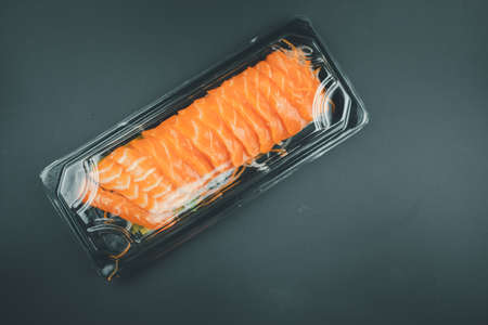 Raw fresh salmon sashimi meat in packaging on a black backgroundの写真素材