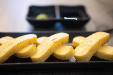 Japanese rolled omelette called "tamagoyaki" a dish made by mixing eggs and soup stockの写真素材