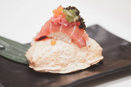 Tuna sushi with roe on top served on crab carapace, luxury menuの写真素材