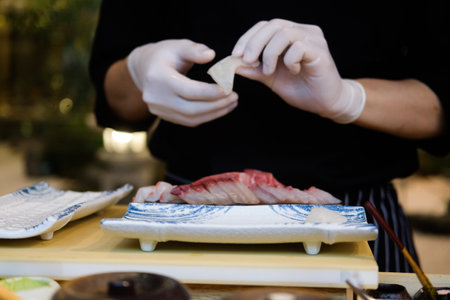 Close up of chef hands preparing Japanese food to serve to a customer at Japanese restaurant