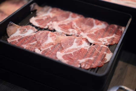 Raw sliced beef in black tray for Shabu Shabu