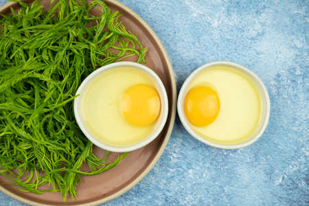 Raw omelet with leaf Climbing Wattle for cooking Cha-om egg. Thai foodの写真素材