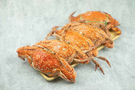 Heap of Thai steamed blue crabs served on wood tray. Close upの写真素材