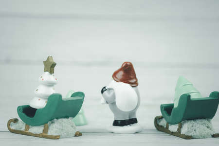 Rear view on the model of Santa Claus while carrying a big bag with presents for Christmas. Happy...