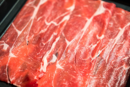 Sliced wagyu beef on a plate that has not yet been cooked in tray for hot potの写真素材