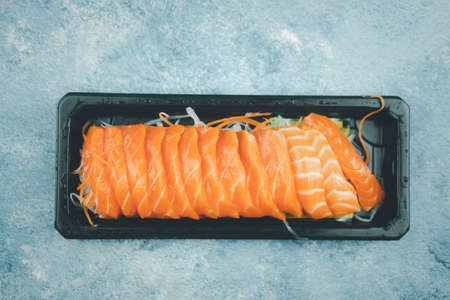 Fresh raw salmon sashimi. Online order food and delivery concept. Selective focusの写真素材