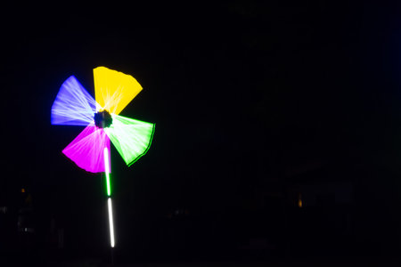 Blurred background wheel with colorful lighting decoration at night fun fairの写真素材