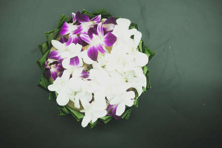 Top view Krathong made from banana leaves and decorated with violet and white orchid, handmade for...