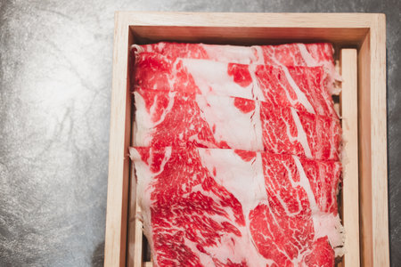 Premium Japanese wagyu beef sliced in wooden box for sukiyakiの写真素材