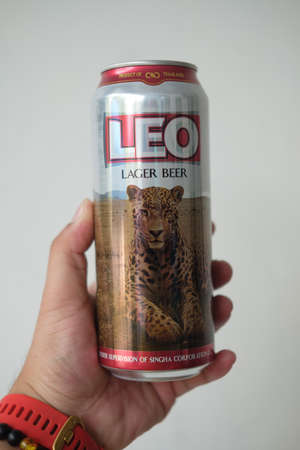 Samut Prakan, Thailand - January 25, 2022 : A man hand holding of new design can of a Leo Beer can,...